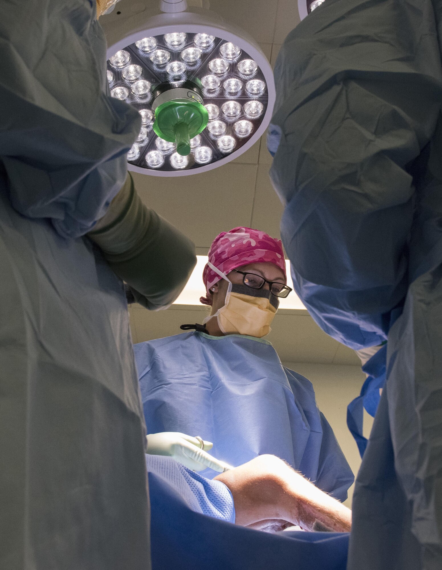 Maj. Marcene McVay, 455th Expeditionary Medical Group general surgeon, calculates her next steps during a surgery on an Afghan patient at Craig- Joint Theater Hospital, June 10, 2016, Bagram Airfield, Afghanistan. McVay worked alongside orthopedic surgeons in a mutitude of surgeries in an effort to save the patient’s leg form being amputated. Surgeons have placed a flap of skin procured from the backside of her legs over the wound to prevent infection and promote healing. (U.S. Air Force photo by Tech. Sgt. Tyrona Lawson)
