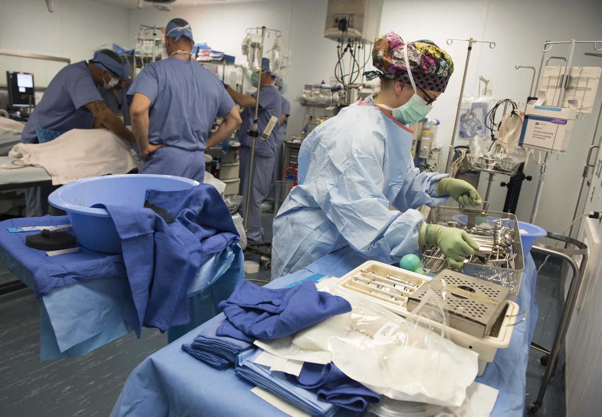 Staff Sgt. Brittany Vonoehmden, 455th Expeditionary Medical Group surgical technician, clears equipment from the surgical setup after a surgery, June 10, 2016, at Craig-Joint Theater Hospital, Bagram Airfield, Afghanistan. Vonoehmden is one of many medical professionals that have rallied around the Afghan patient in an effort to save her leg from amputation. (U.S. Air Force photo by Tech. Sgt. Tyrona Lawson)