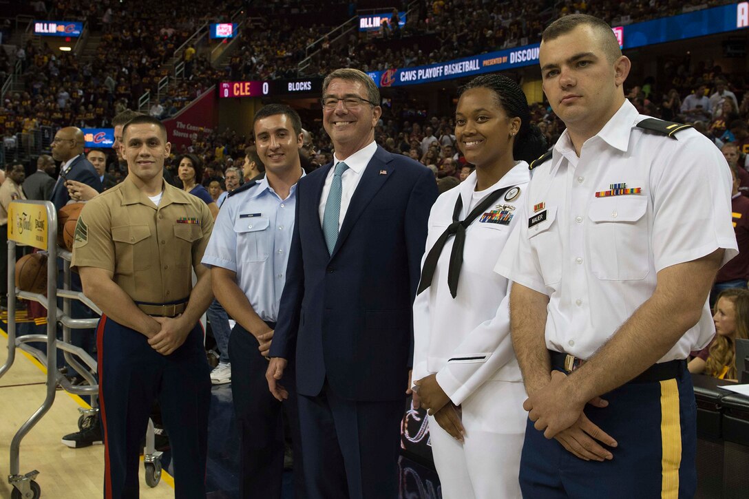 Defense Secretary Ash Carter takes a photo with service members at Game 4 of the 2016 NBA Finals in Cleveland, June 10, 2016. The four service members, representing the Army, Navy, Marine Corps and Air Force, were honored on the court in a pregame ceremony. DoD photo by Navy Petty Officer 1st Class Tim D. Godbee
