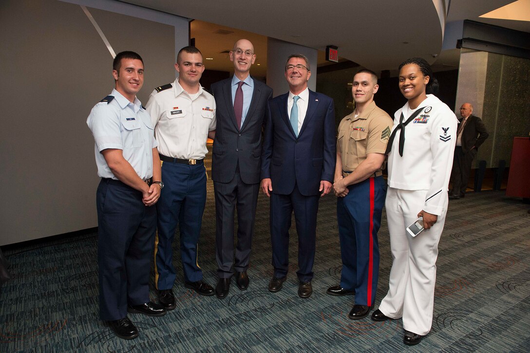 Defense Secretary Ash Carter and NBA commissioner Adam Silver pose with service members at Game 4 of the 2016 NBA Finals in Cleveland, June 10, 2016. The four service members, representing the Army, Navy, Marine Corps and Air Force, were honored on the court in a pregame ceremony. DoD photo by Navy Petty Officer 1st Class Tim D. Godbee
