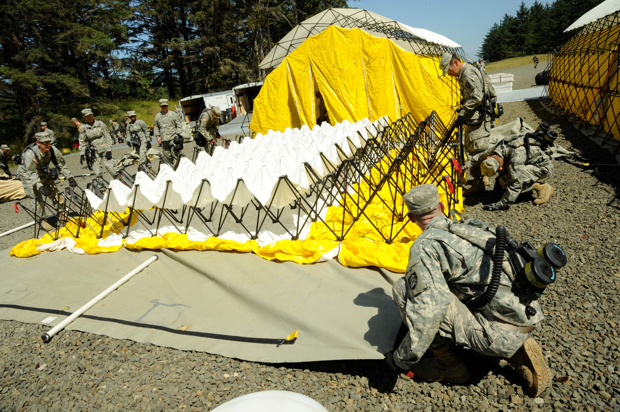 The CBRNE Enhanced Force Response Force Package (CERFP) members from the Oregon and Kentucky National Guard work together to set up medical faculties during the Cascadia Rising exercise at Camp Rilea, Warrenton, Ore., June 7, 2016. Cascadia Rising scenario is a 9.0 magnitude earthquake along the Cascadia Subduction Zone (CSZ) resulting in a tsunami, testing first responders, emergency management and public safety officials in the Pacific Northwest. (U.S. Air National Guard photo by Tech. Sgt. John Hughel, 142nd Fighter Wing Public Affairs/Released) 