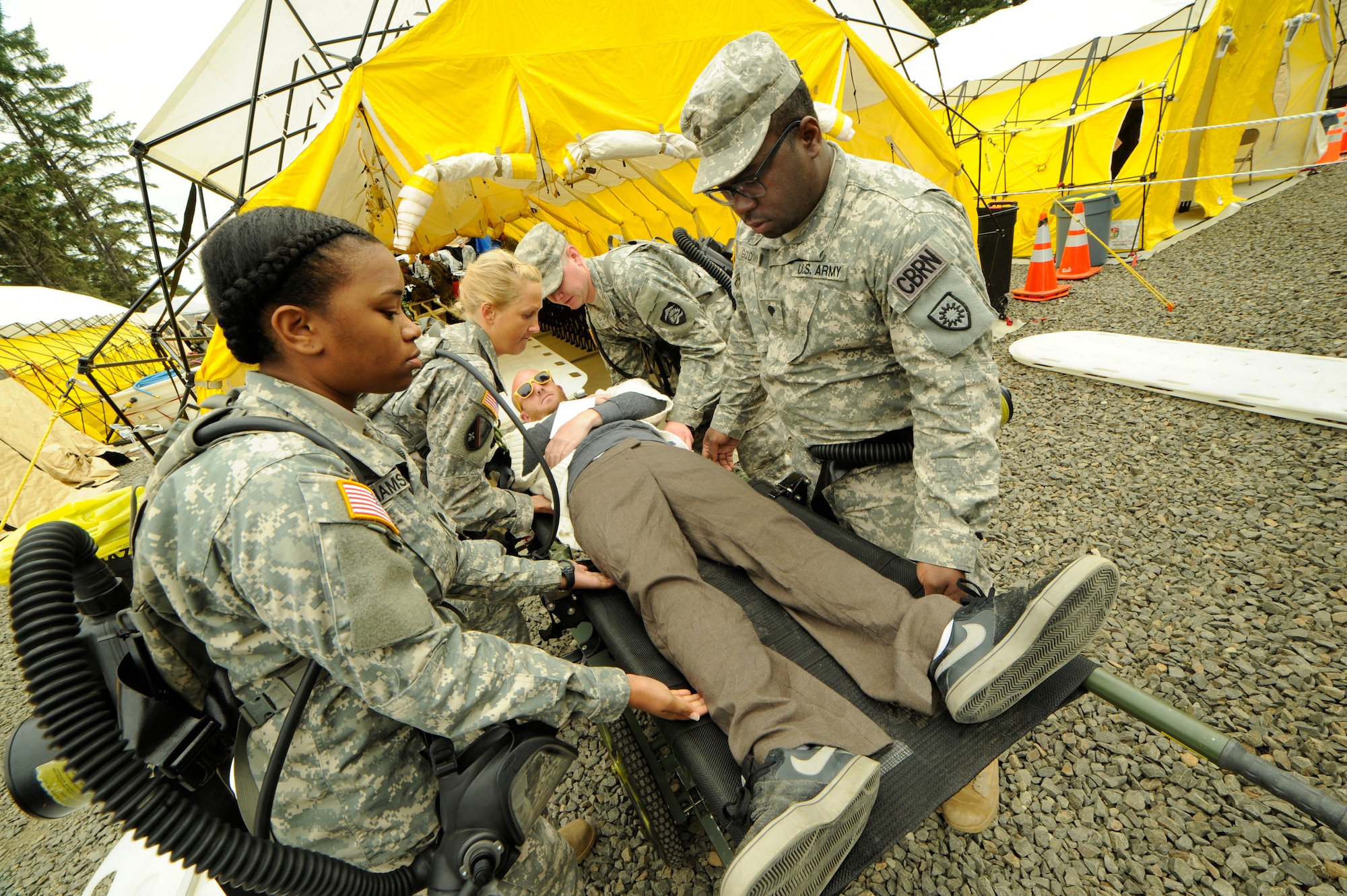 The CBRNE Enhanced Force Response Force Package (CERFP) members from the Oregon and Kentucky National Guard treat injured victims during the Cascadia Rising exercise at Camp Rilea, Warrenton, Ore., June 9, 2016. Cascadia Rising scenario is a 9.0 magnitude earthquake along the Cascadia Subduction Zone (CSZ) resulting in a tsunami, testing first responders, emergency management and public safety officials in the Pacific Northwest. (U.S. Air National Guard photo by Tech. Sgt. John Hughel, 142nd Fighter Wing Public Affairs/Released)