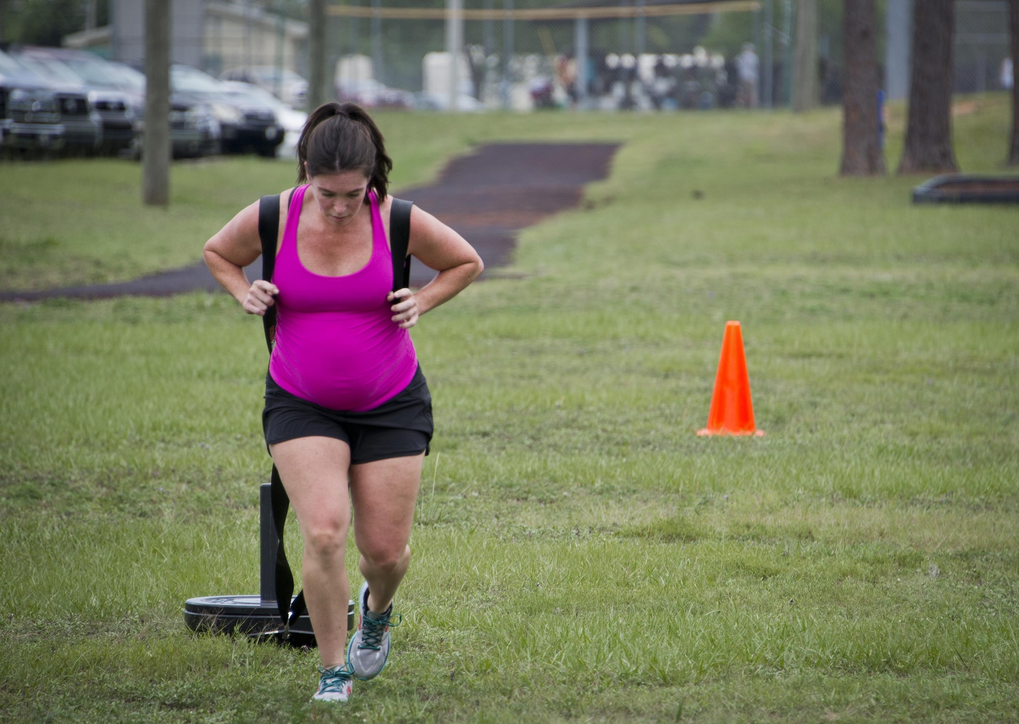 Tech. Sgt. Kristina Dean, 919th Special Operations Maintenance Group, pulls a weighted sled toward the finish line during a team combat fit competition June 11 at Duke Field, Fla.   Dean, a former fitness trainer, competed and completed all the challenges in the event while being six and a half months pregnant with her third child.  Her team went on to win the female competition. The three-round competition pushed the teams to their limits with repetitive weight lifting, rowing, sled-pulling and other kinetic activities.  (U.S. Air Force photo/Tech. Sgt. Sam King)