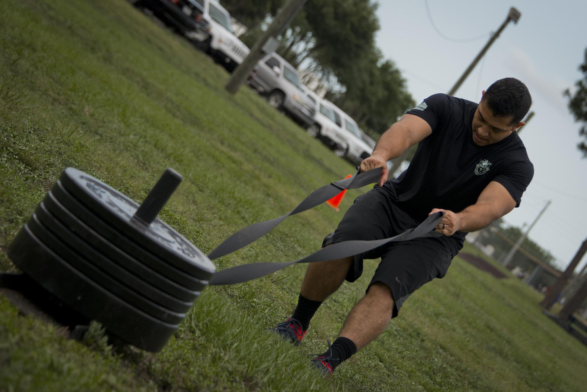 Spc. Jose Castillo, 7th Special Forces Group, pulls a weighted sled toward the finish line during a team combat fit competition June 11 at Duke Field, Fla.  The three-round competition pushed the teams to their limits with repetitive weight lifting, rowing, sled-pulling and other kinetic activities.  (U.S. Air Force photo/Tech. Sgt. Sam King)