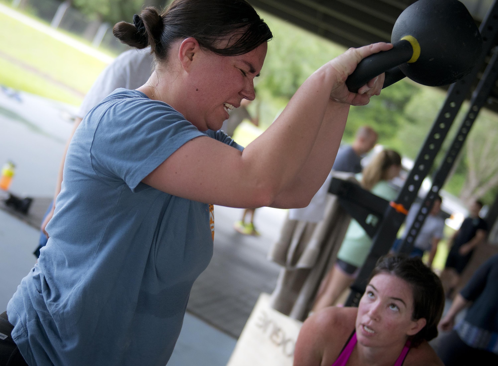 Tech. Sgt. Amanda King, 919th Special Operations Civil Engineer Squadron, struggles to lift a kettlebell over her head during a team combat fit competition June 11 at Duke Field, Fla.  The three-round competition pushed the teams to their limits with repetitive weight lifting, rowing, sled-pulling and other kinetic activities.  (U.S. Air Force photo/Tech. Sgt. Sam King)