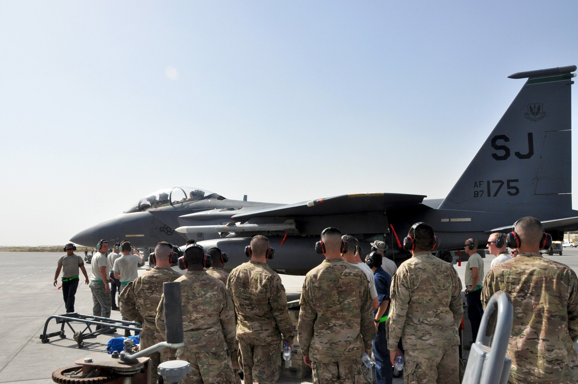 Soldiers from the Army 3rd Battalion 2nd Air Defense Artillery Regiment watch May 17 as 380th Expeditionary Aircraft Maintenance Squadron Airmen power down an F-15 Strike Eagle. The visit was part of an information exchange between the Air Force and Army to enhance understanding of how the services work in tandem to cultivate air superiority. (U.S. Air Force photo by Staff Sgt. Samantha Mathison)