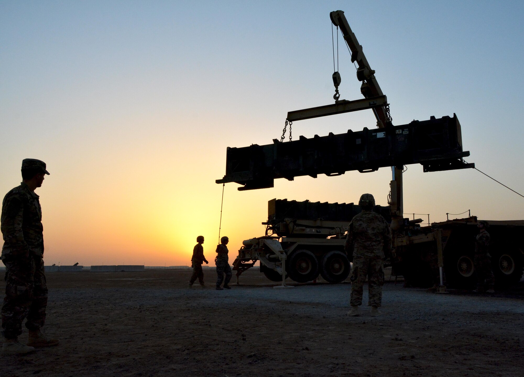 Soldiers from the Army 3rd Battalion 2nd Air Defense Artillery Regiment assist 380th Expeditionary Aircraft Maintenance Squadron Airmen to guide a Patriot training missile during the load of a launcher, June 4. The Airmen’s visit was part of an information exchange between the Air Force and Army to enhance understanding of how the services work in tandem to cultivate air superiority. (U.S. Air Force photo by Staff Sgt. Samantha Mathison)