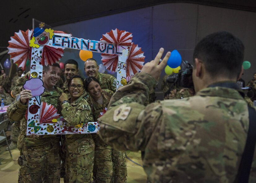 Airmen from the 455th Expeditionary Aeromedical Evacuation Squadron pose for a photo during the carnival block party hosted by the 455th Expeditionary Force Support Squadron, at Bagram Airfield, Afghanistan, June 11, 2016. All purchase proceeds made through the 455 EFSS facilities goes directly back to the base community for events such as these. (U.S. Air Force photo by Senior Airman Justyn M. Freeman)