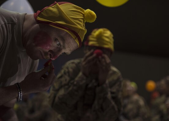 Tech. Sgt. Kevin Dilley, 455th Air Expeditionary Wing chaplain's assistant, puts on clown makeup during a carnival block party hosted by the 455th Expeditionary Force Support Squadron, at Bagram Airfield, Afghanistan, June 11, 2016. All purchase proceeds made through the 455 EFSS facilities goes directly back to the base community for events such as these. (U.S. Air Force photo by Senior Airman Justyn M. Freeman)