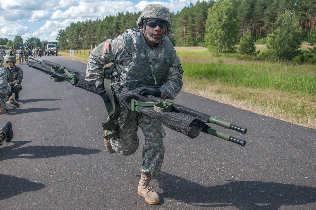 A soldier assigned to the 212th Combat Support Hospital runs a stretcher to the medevac landing zone in Miloslawiec, Poland, June 11, 2016. The mass casualty drill is part of Anakonda 2016, a Polish-led, multinational exercise involving troops from more than 20 nations. Army photo by Sgt. 1st Class John Fries
