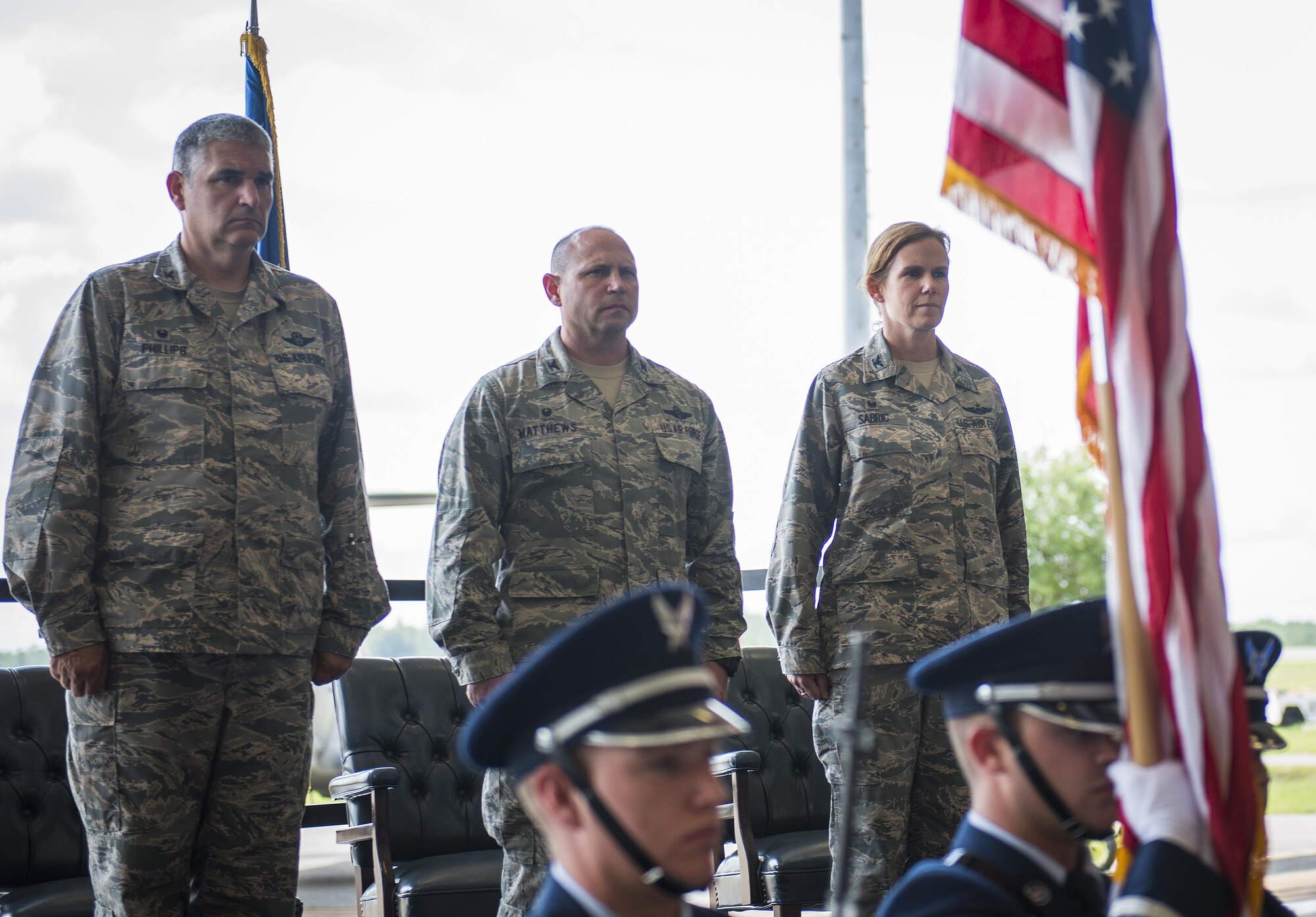 Col. James Phillips, the 919th Special Operations Wing commander, stands with the outgoing and incoming commanders at the 919th Special Operations Group’s change of command ceremony June 12 at Duke Field, Fla.  Col. Regina Sabric was stationed at the Pentagon before becoming the first female commander of the group.  U.S. Air Force photo/Tech. Sgt. Sam King)