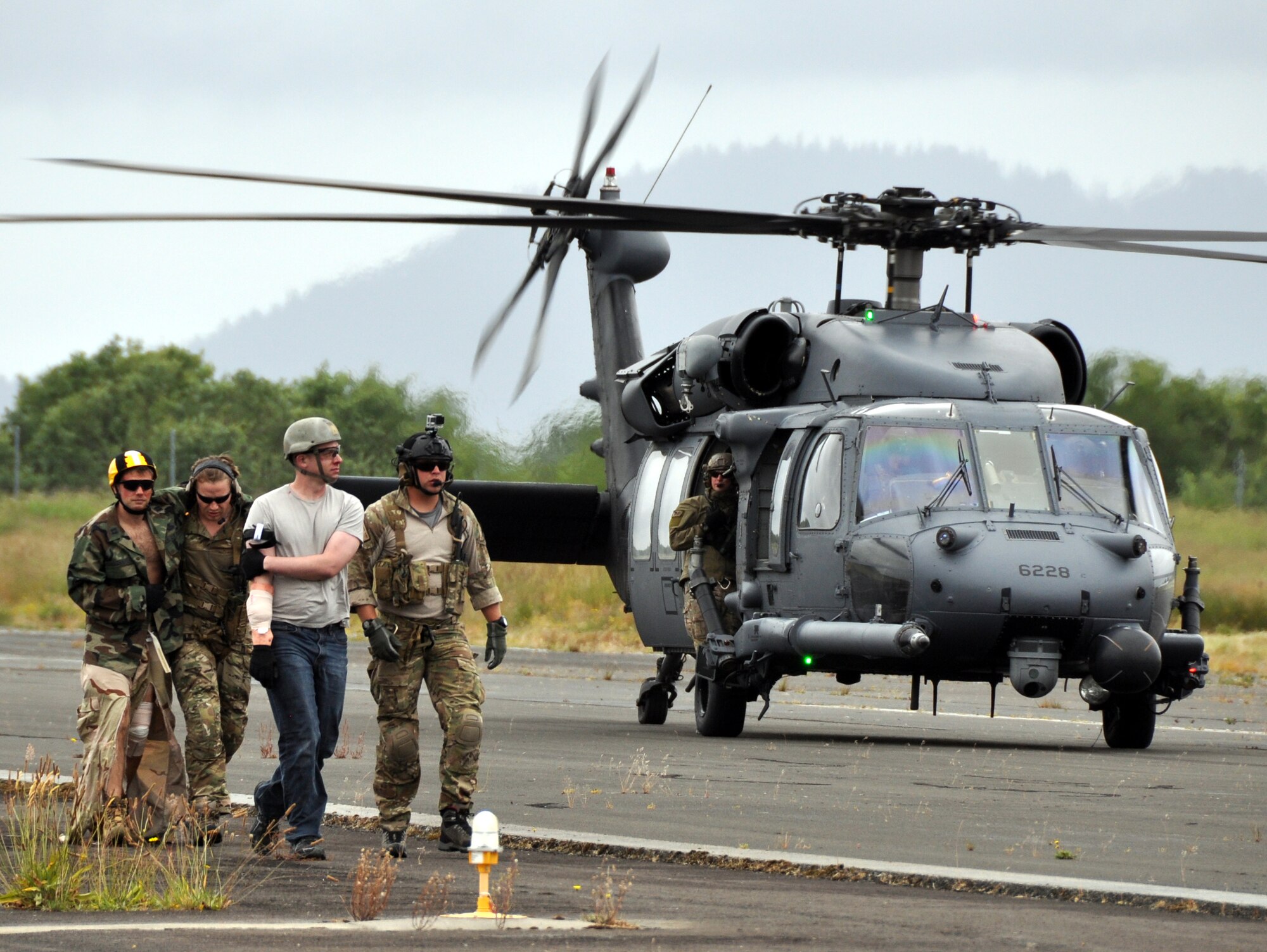 Pararescuemen from the 304th Rescue Squadron, Portland Air National Guard Base, Ore., exit an HH-60G Pave Hawk helicopter from the 305th Rescue Squadron, Davis-Monthan Air Force Base, Ariz., with fellow 304th reservists simulating casualties June 8, 2016 at the airport in Astoria, Ore. Several 304th personnel, plus Air and Army National Guardsmen and other local, state and federal government and civilian organizations participated in Cascadia Rising, a disaster response exercise simulating a magnitude 9.0 earthquake and subsequent tsunami in the Pacific Northwest. (U.S. Air Force photo by 1st Lt. Anna-Marie Wyant)