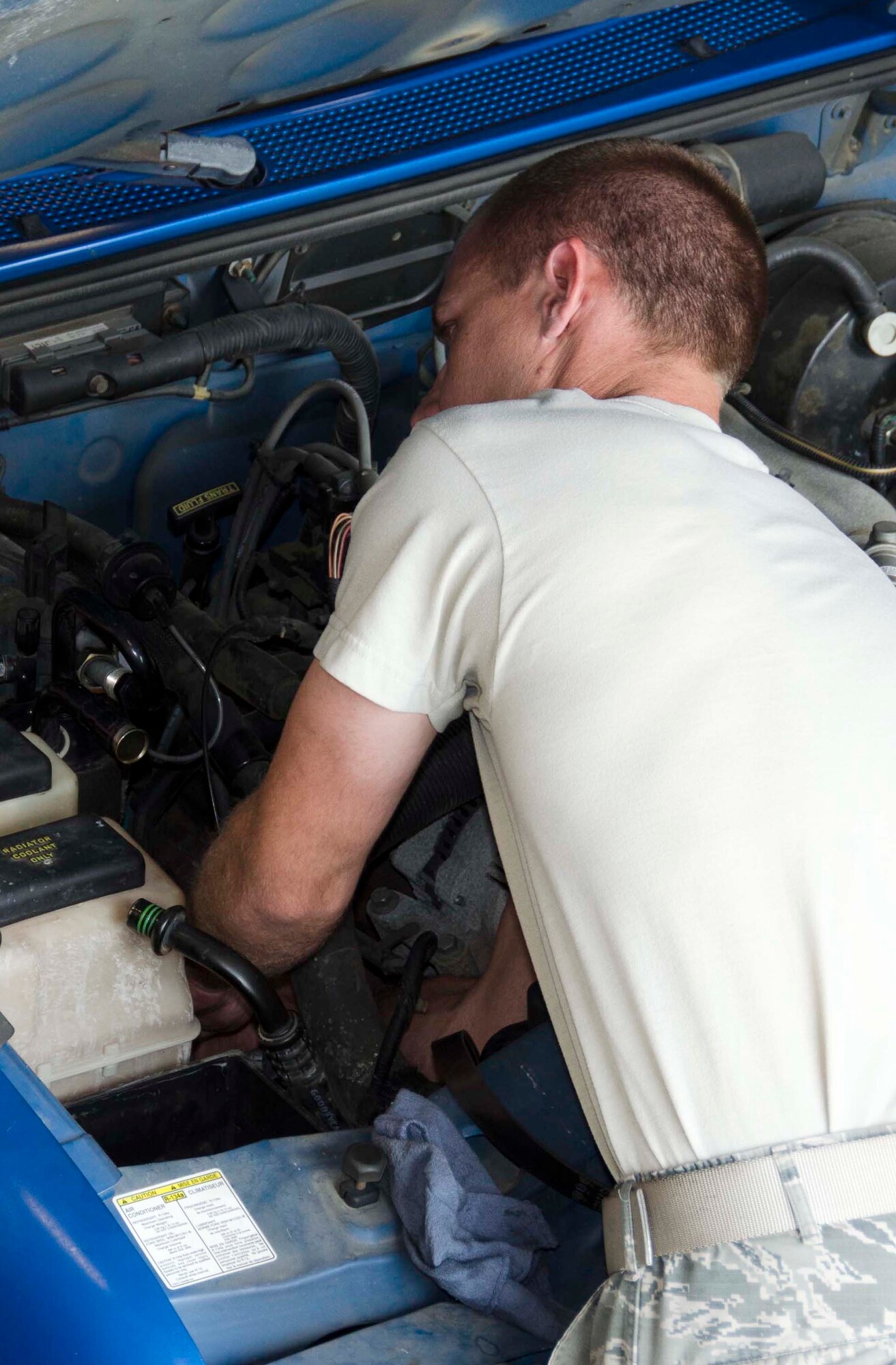 Tech. Sgt. Chad Bennett and Staff Sgt. Wade Spradlin, Vehicle Maintainers from the 117th Logistical Readiness Squadron at the 117th Air Refueling Wing, replace a broken air compressor inside a security forces truck June 11, 2016 in Birmingham, Ala. (Air National Guard photo by Senior Airman Wes Jones/Released)
