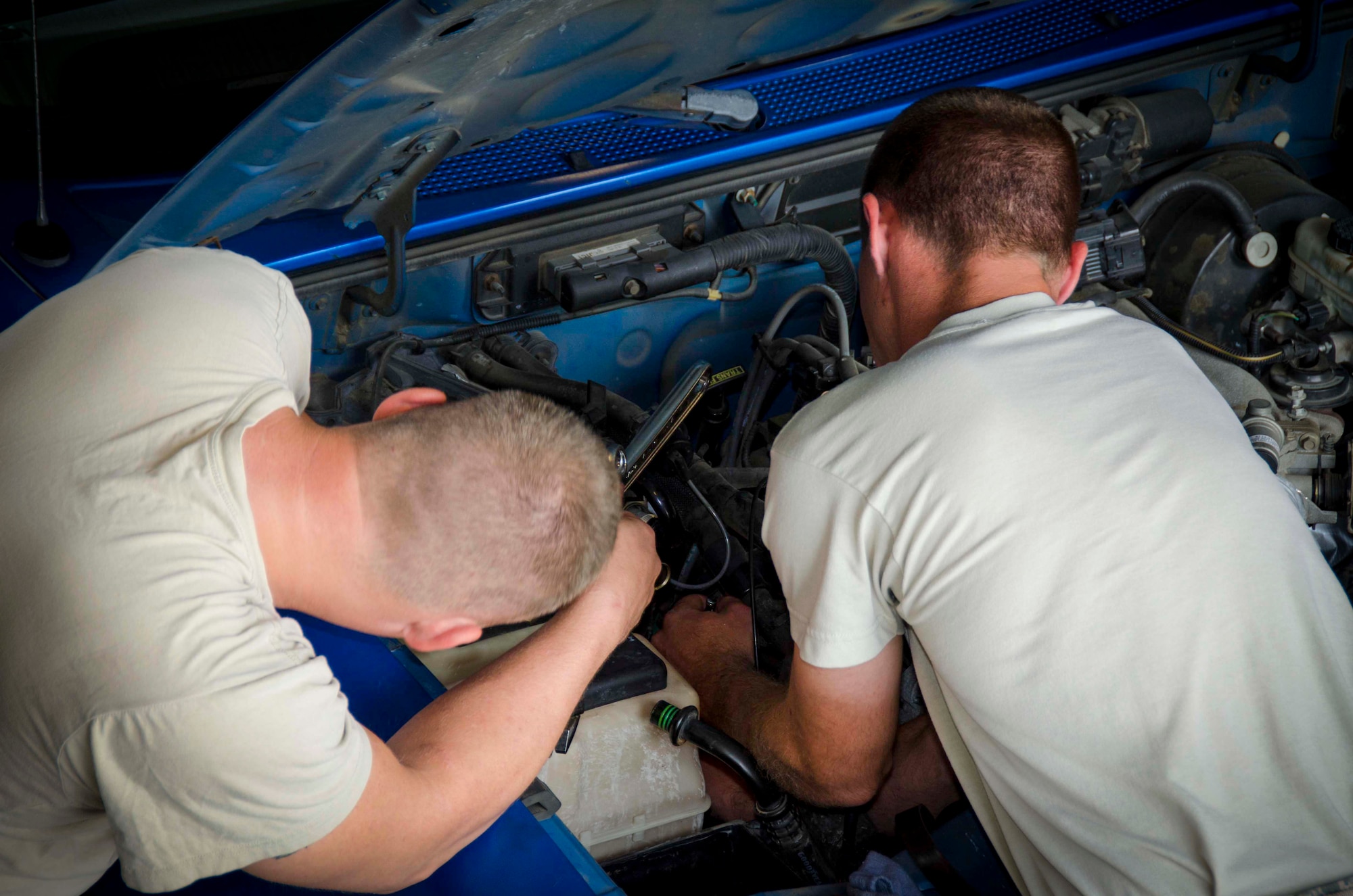 Tech. Sgt. Chad Bennett and Staff Sgt. Wade Spradlin, Vehicle Maintainers from the 117th Logistical Readiness Squadron at the 117th Air Refueling Wing, replace a broken air compressor inside a security forces truck June 11, 2016 in Birmingham, Ala. (Air National Guard photo by Senior Airman Wes Jones/Released)