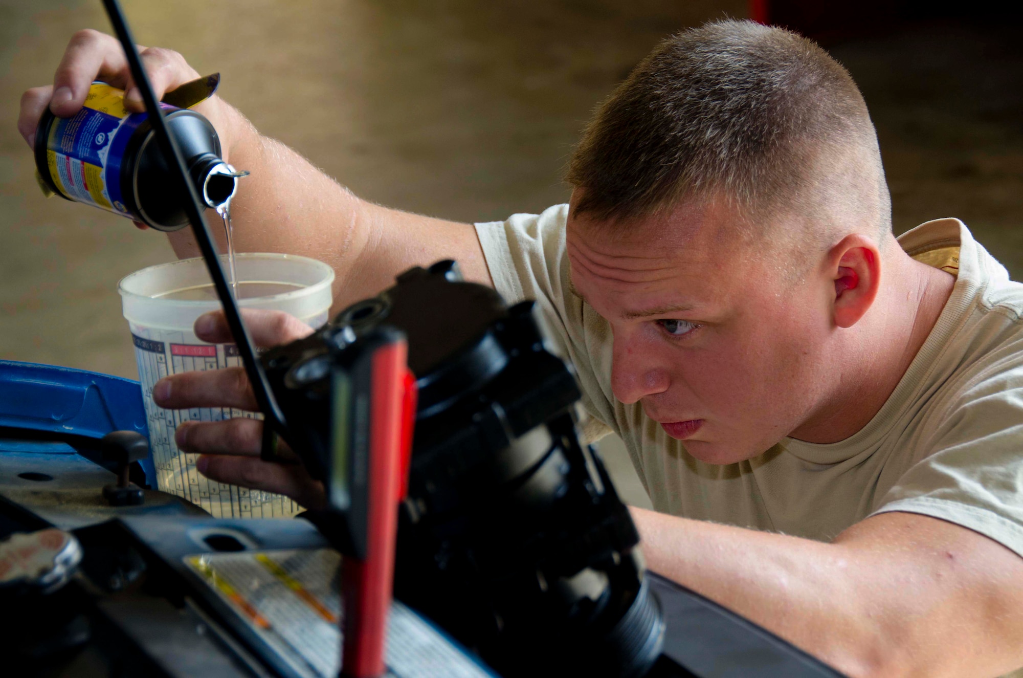 Tech. Sgt. Chad Bennett and Staff Sgt. Wade Spradlin, Vehicle Maintainers from the 117th Logistical Readiness Squadron at the 117th Air Refueling Wing, replace a broken air compressor inside a security forces truck June 11, 2016 in Birmingham, Ala. (Air National Guard photo by Senior Airman Wes Jones/Released)