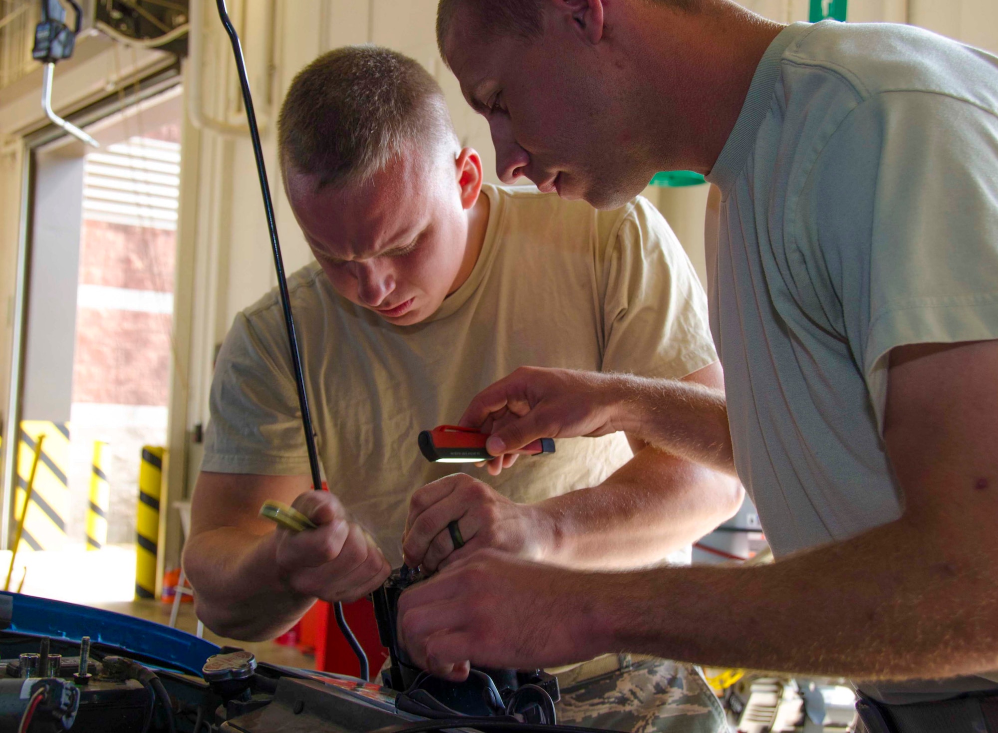 Tech. Sgt. Chad Bennett and Staff Sgt. Wade Spradlin, Vehicle Maintainers from the 117th Logistical Readiness Squadron at the 117th Air Refueling Wing, replace a broken air compressor inside a security forces truck June 11, 2016 in Birmingham, Ala. (Air National Guard photo by Senior Airman Wes Jones/Released)