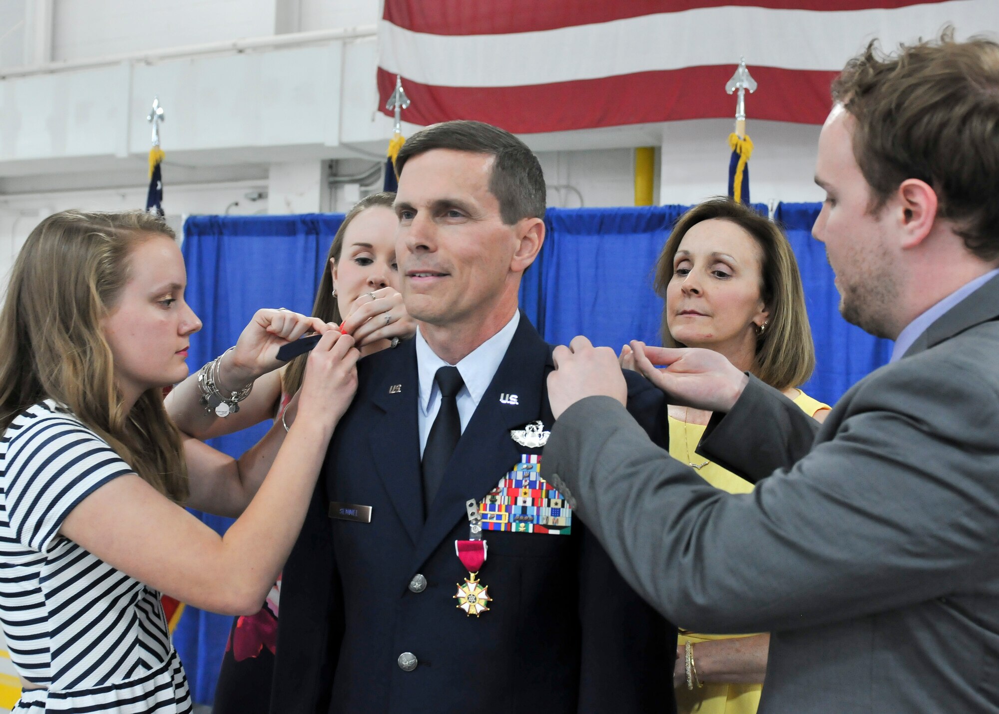 Former 174th Attack Wing Commander Col. Greg Semmel is pinned by his family, commemorating his promotion to brigadier general, during his promotion ceremony held on Hancock Field in Syracuse, NY Friday, June 10. Semmel will now serve as Assistant Adjutant General – Air for the New York Air National Guard. (U.S. Air National Guard photo by Tech. Sgt. Jeremy M. Call/Released)