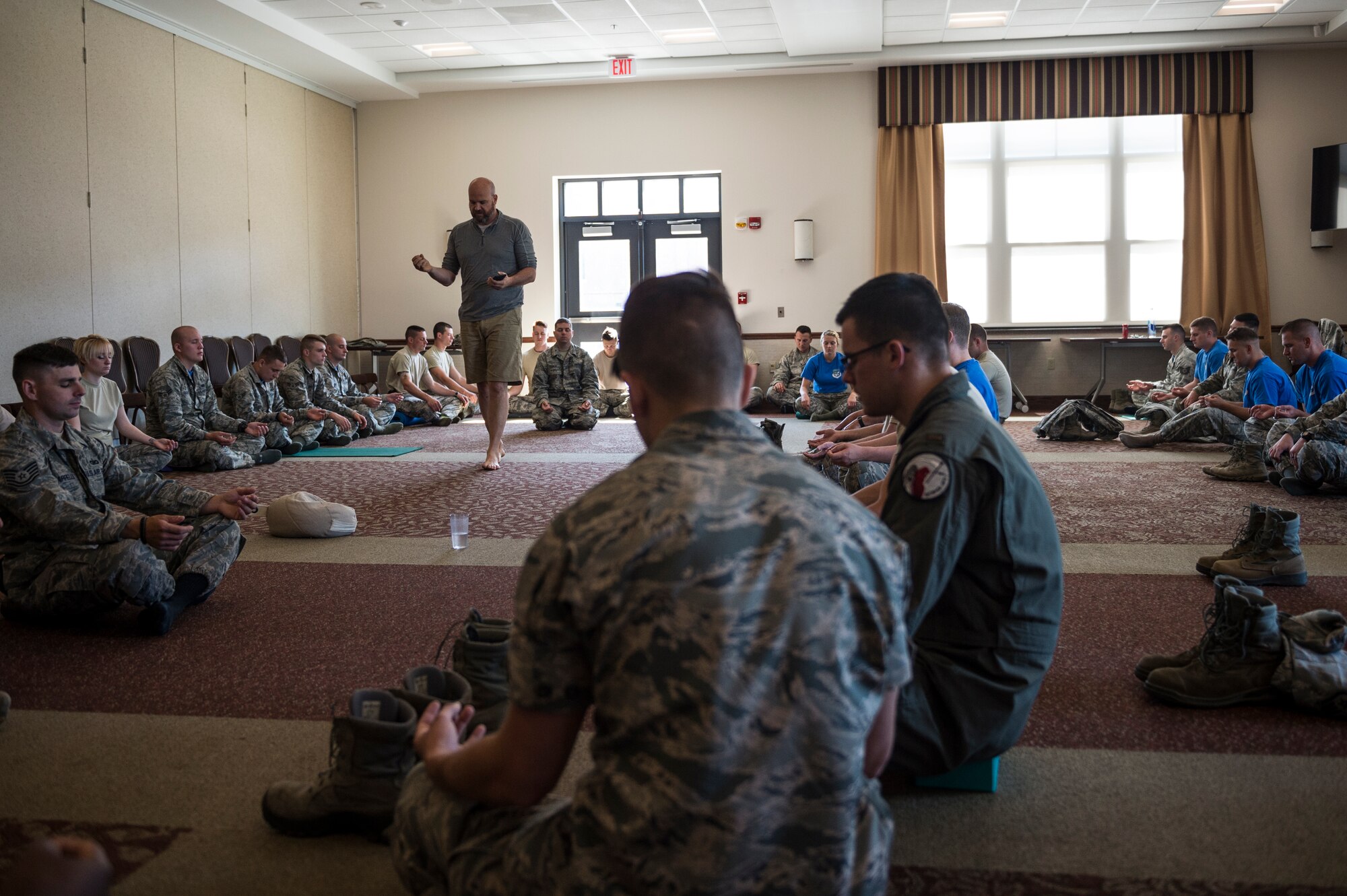 Airmen from the 107th Airlift Wing participate in a meditation class given by Soma Cura as part of Wellness Week at Niagara Falls Air Reserve Station, June 10, 2016. Soma Cura, a local wellness center, was on base offering introductory classes to mediation as well as yoga, as part of the various classes taking part during Wellness Week. (U.S. Air National Guard photo by Staff Sgt. Ryan Campbell/released)