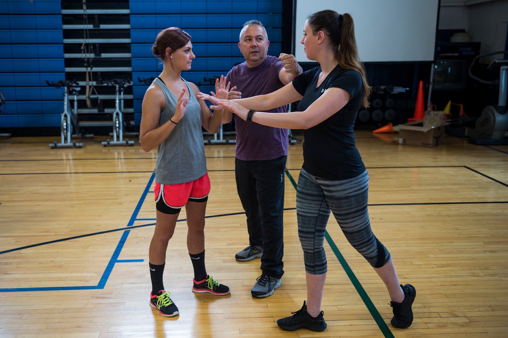 Airmen from the 107th Airlift Wing receive instruction on self-defense techniques during a class as part of Wellness Week at Niagara Falls Air Reserve Station, June 8, 2016. Wellness Week featured a variety of classes for the 107th Airmen, ranging from physical and spiritual fitness to financial responsibility. (U.S. Air National Guard photo by Staff Sgt. Ryan Campbell/released)