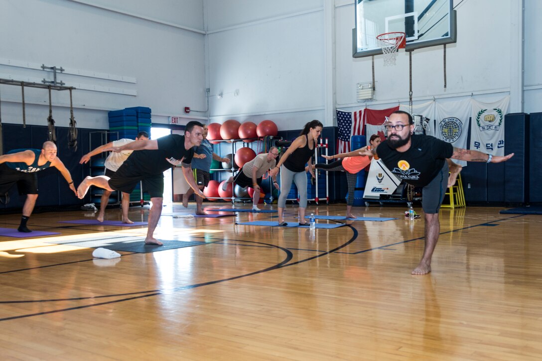 Airmen from the 107th Airlift Wing participate in a yoga class given by Soma Cura as part of Wellness Week at Niagara Falls Air Reserve Station, June 6, 2016. Soma Cura, a local wellness center, was on base offering introductory classes to mediation as well as yoga, as part of the various classes taking part during Wellness Week. (U.S. Air National Guard photo by Senior Master Sgt. Ray Lloyd/released)