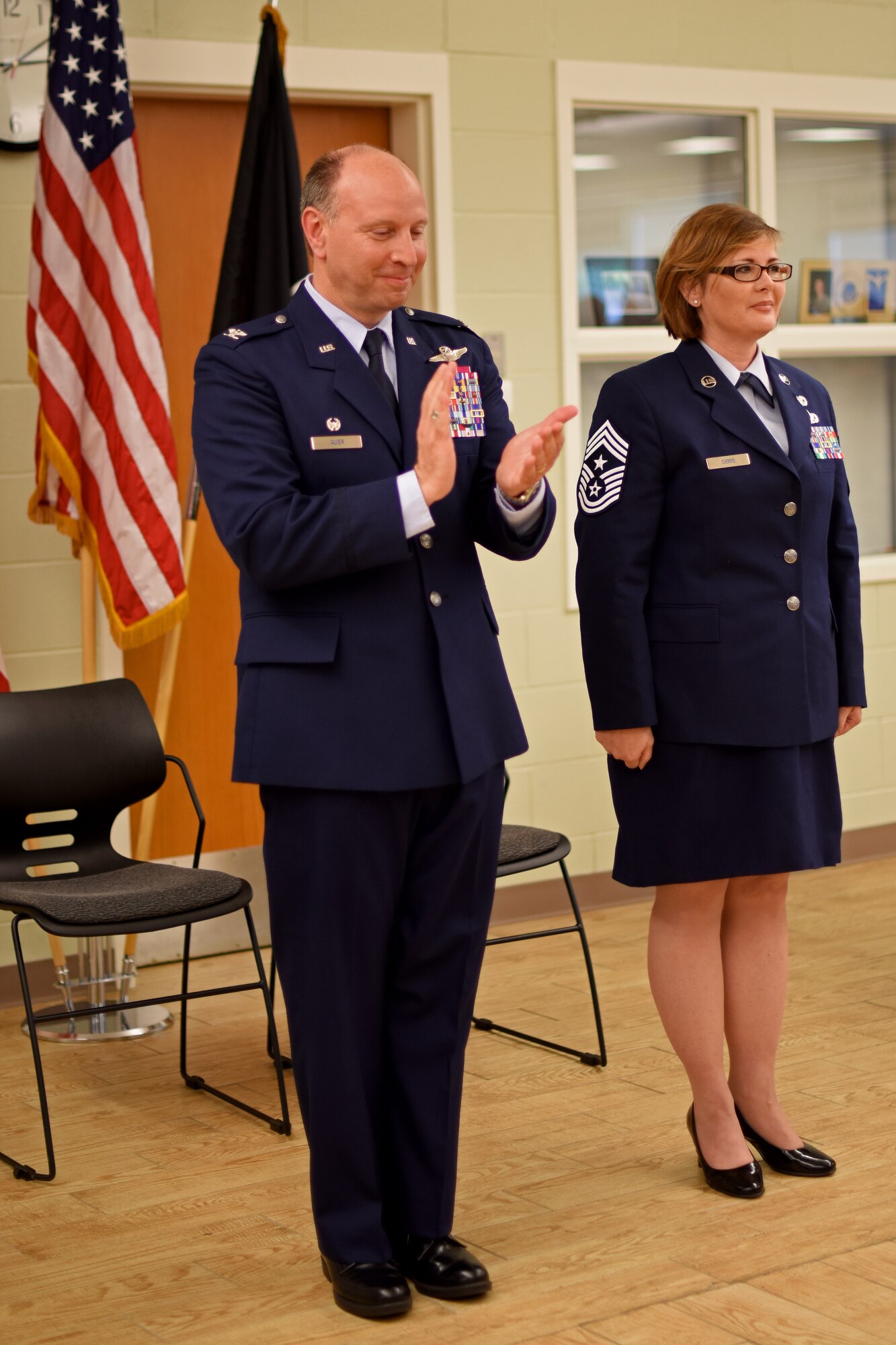 U.S. Air Force Col. Mark Auer (left), 121st Air Refueling Wing commander, and Chief Master Sgt. Kelly Gibbs (right), command chief, take part in an assumption of command ceremony on June 11, 2016, Rickenbacker Air National Guard Base, Ohio. As the unit's newest command chief, Chief Master Sgt. Gibbs is responsible for advising the commander on matters of mission effectiveness; readiness; training and the health, morale and welfare of all 121 ARW enlisted members. (U.S. Air National Guard photo by Senior Airman Wendy Kuhn/Released)