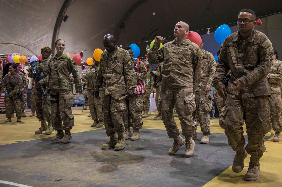 Service members dance the night away during a carnival block party hosted by the 455th Expeditionary Force Support Squadron at Bagram Airfield, Afghanistan, June 11, 2016. The event relieves stress and helps troops cope with being away from their loved ones. Air Force photo by Senior Airman Justyn M. Freeman