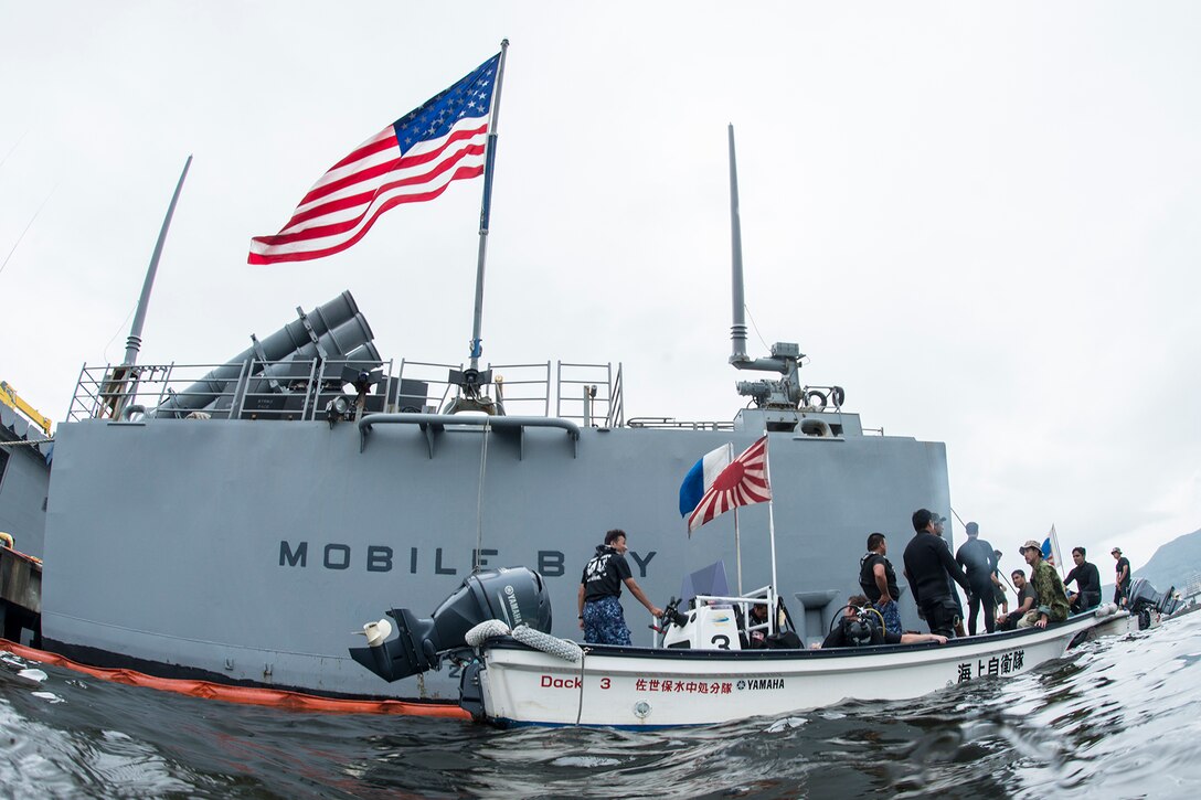 Explosive ordnance disposal technicians from the Indian Navy, Japan Maritime Self-Defense Force and U.S. Navy prepare to dive under the guided-missile cruiser USS Mobile Bay during exercise Malabar 2016 at U.S. Fleet Activities Sasebo, Japan, June 12, 2016. Navy photo by Petty Officer 1st Class Charles E. White