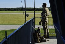A tactical air control party Airman from the 4th Air Support Operations Squadron observes the airfield as he communicates with ground forces during Exercise Anakonda 2016 June 9, 2016, at Swidwin Air Base, Poland. Exercise Anakonda 2016 is a Polish-led exercise, involving several nations, with over 25,000 participants from more than 20 countries. (U.S. Air Force photo/Airman 1st Class Lane T. Plummer)