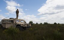 U.S. Air Force Staff Sgt. Thad Taylor, 15th Air Space Operations Squadron joint terminal attack controller, scouts the landscape as he participates in Exercise Anakonda 2016 June 10, 2016, at Poland. Exercise Anakonda 2016 is a Polish-led exercise, involving several nations, with over 25,000 participants from more than 20 countries. (U.S. Air Force photo/Airman 1st Class Lane T. Plummer)