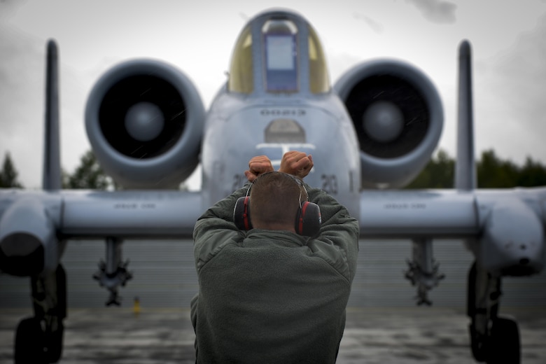 A crew chief guides an A-10C Thunderbolt II pilot into parking position at Lielvarde Air Base, Latvia June 11, 2016.  Members of the 107th Fighter Squadron, Selfridge Air National Guard Base, Michigan join other U.S. armed forces and Latvian airmen to participate in Saber Strike 16; a long-standing, U.S. Joint Chiefs of Staff-directed, U.S. Army Europe-led cooperative-training exercise, which has been conducted annually since 2010. This year’s exercise will focus on promoting interoperability with allies and regional partners.  (U.S. Air Force photo/Senior Airman Nicole Keim)