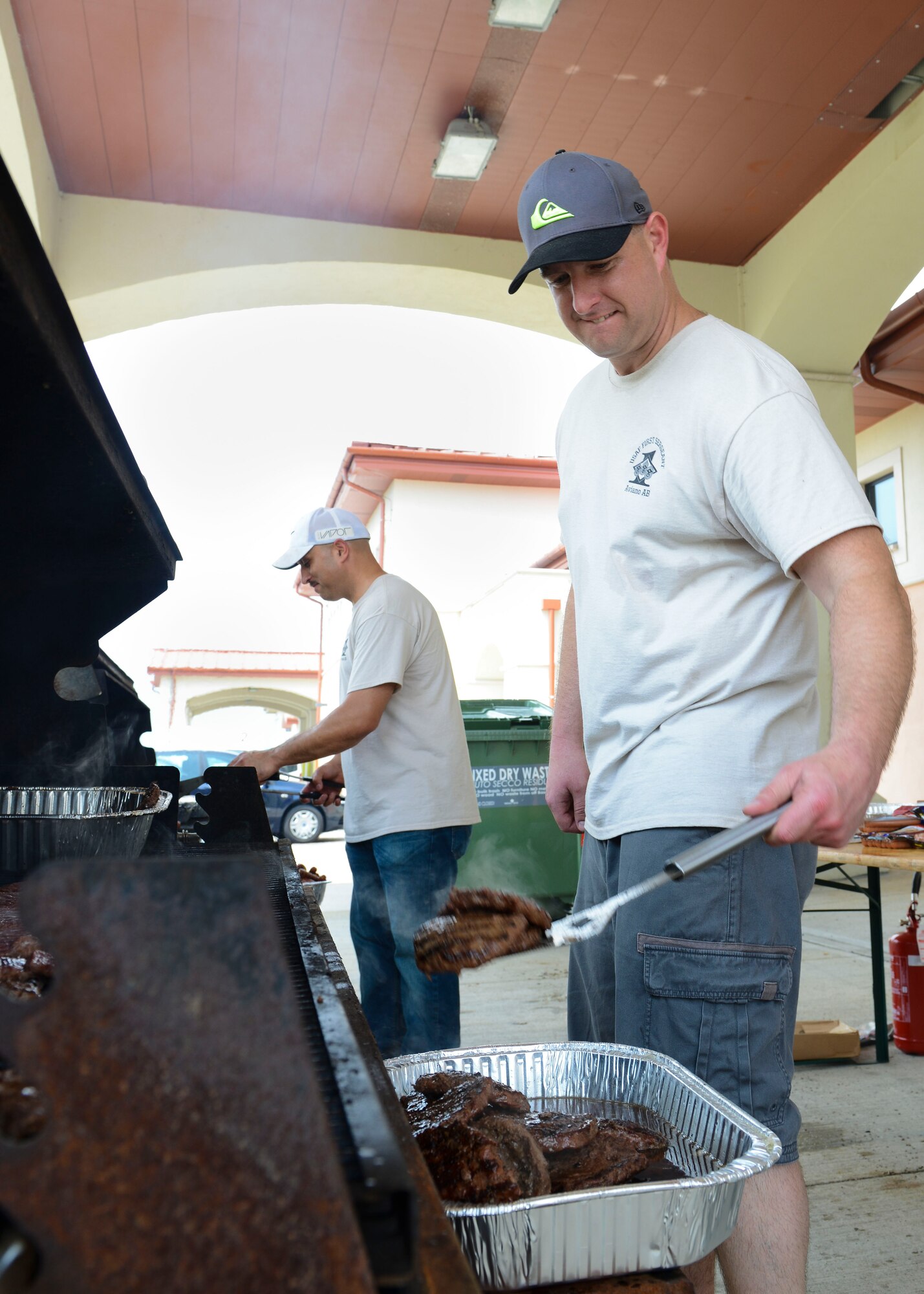 Master Sgt. John Ritz, 31st Medical Group first sergeant, cooks burgers for a wing picnic, June 9, 2016, at Aviano Air Base, Italy. The Aviano First Sergeant’s Council, 31st Medical Group and 31st Force Support Squadron supported the event by providing games and free food to attendees. (U.S. Air Force photo by Senior Airman Austin Harvill/Released)