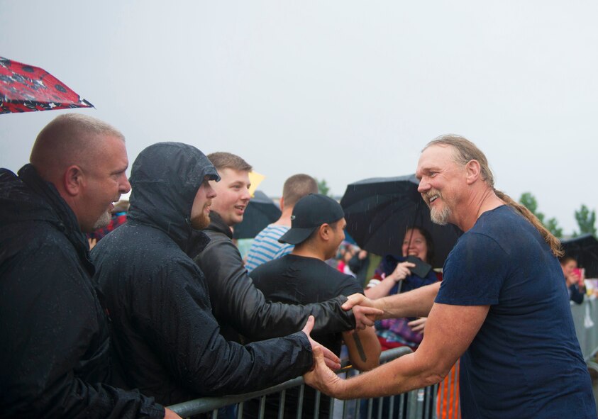Trace Adkins, country music singer, shakes audience members’ hands during a free concert at Ramstein Air Base, Germany, June 11, 2016. Adkins came down from the stage to greet fans after the event was briefly interrupted by heavy rain. (U.S. Air Force photo/ Airman 1st Class Joshua Magbanua)