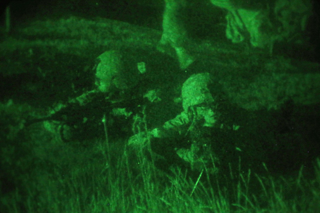 As seen through a night-vision device, soldiers provide security in an air assault operation on a mock town during Operation Anakonda 2016 in Wedrzyn, Poland, June 11, 2016. Army photo by Sgt. Ashley Marble