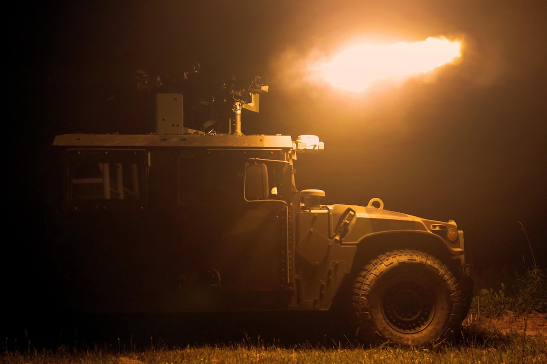 A soldier fires a machine gun from the turret of a Humvee during Operation Anakonda 2016 in Wedrzyn, Poland, June 11, 2016. Army photo by Sgt. Jason Edwards