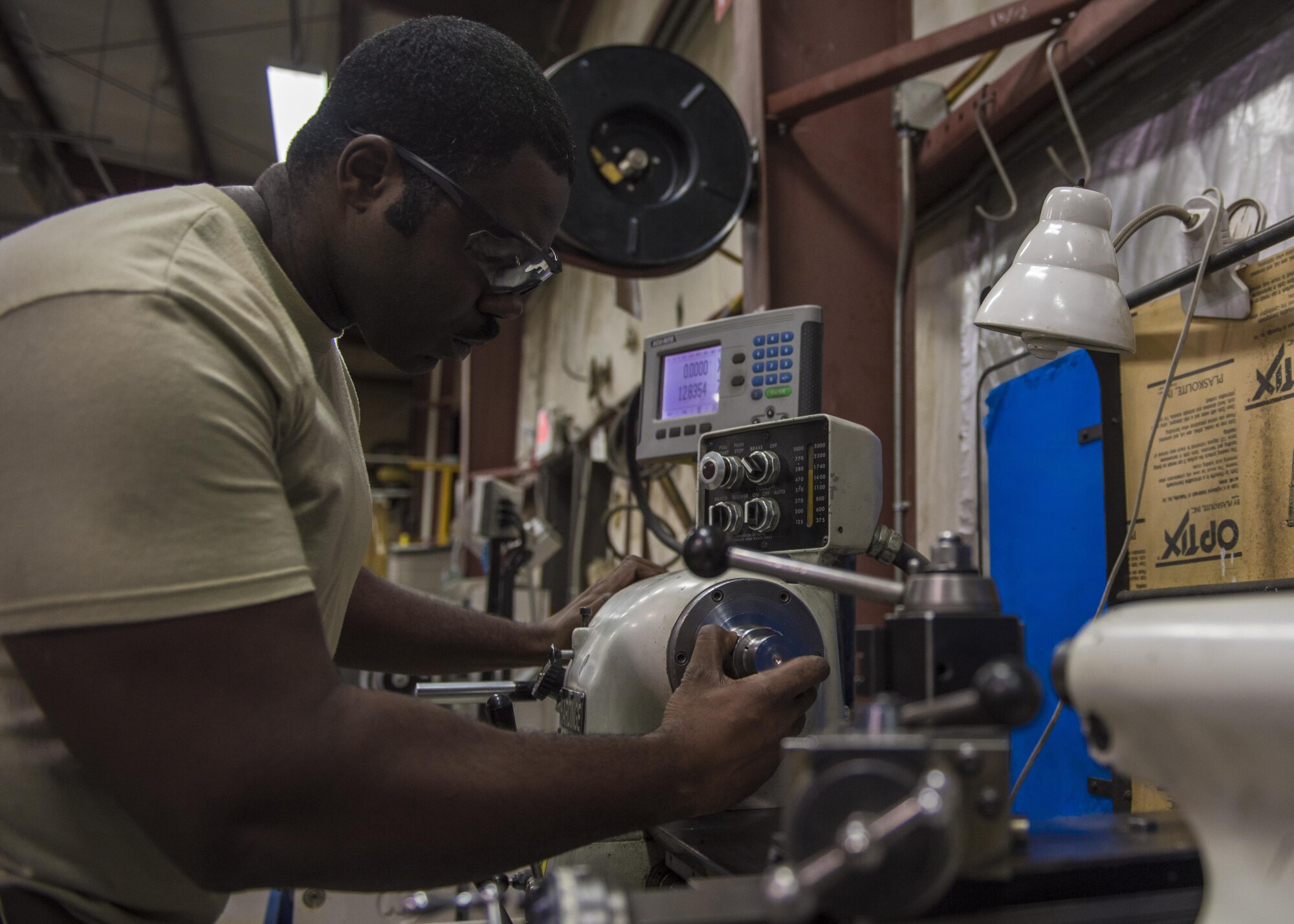 Staff Sgt. Brandon Wilson, 455th Expeditionary Maintenance Squadron aircraft metals technician, fabricates cylindrical aircraft parts on a tool room lathe, June 09, 2016, Bagram Airfield, Afghanistan. The aircraft metals technology section consist of machinists and welders that are trained to use various pieces of equipment to bend, cut and combine metals. (U.S. Air Force photo by Senior Airman Justyn M. Freeman)