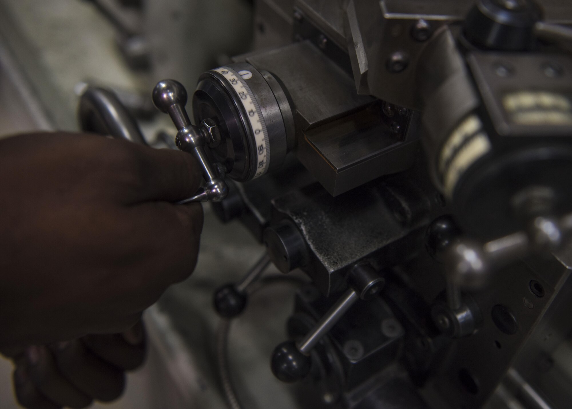 Staff Sgt. Brandon Wilson, 455th Expeditionary Maintenance Squadron aircraft metals technician, adjusts the dials on a tool room lathe, June 09, 2016, Bagram Airfield, Afghanistan. Metals technology inspects, machines, and manufactures aerospace weapons systems and ground equipment. (U.S. Air Force photo by Senior Airman Justyn M. Freeman)