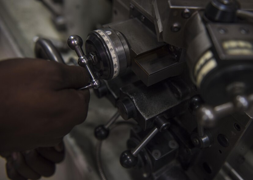 Staff Sgt. Brandon Wilson, 455th Expeditionary Maintenance Squadron aircraft metals technician, adjusts the dials on a tool room lathe, June 09, 2016, Bagram Airfield, Afghanistan. Metals technology inspects, machines, and manufactures aerospace weapons systems and ground equipment. (U.S. Air Force photo by Senior Airman Justyn M. Freeman)
