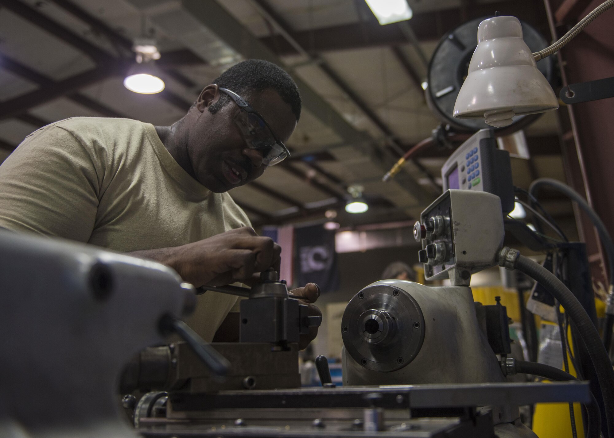 Staff Sgt. Brandon Wilson, 455th Expeditionary Maintenance Squadron aircraft metals technician, makes adjustments on a tool room lathe, June 09, 2016, Bagram Airfield, Afghanistan. The aircraft metals technology shop is trained to use various pieces of equipment to bend, cut and combine metals. (U.S. Air Force photo by Senior Airman Justyn M. Freeman)