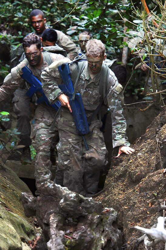 Soldiers traverse a tight stretch of rocky terrain at the French jungle warfare school in Gabon, June 9, 2016. Army photo by Staff Sgt. Candace Mundt 