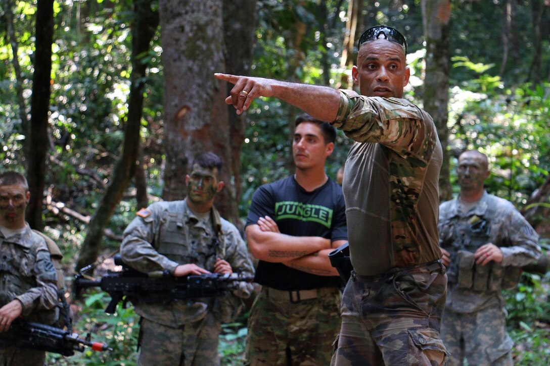 A French army jungle warfare school instructor, third from left, briefs a U.S. Army jungle operations training center instructor on steps for detainee handling at the French jungle warfare school in Gabon, June 9, 2016. Army photo by Staff Sgt. Candace Mundt