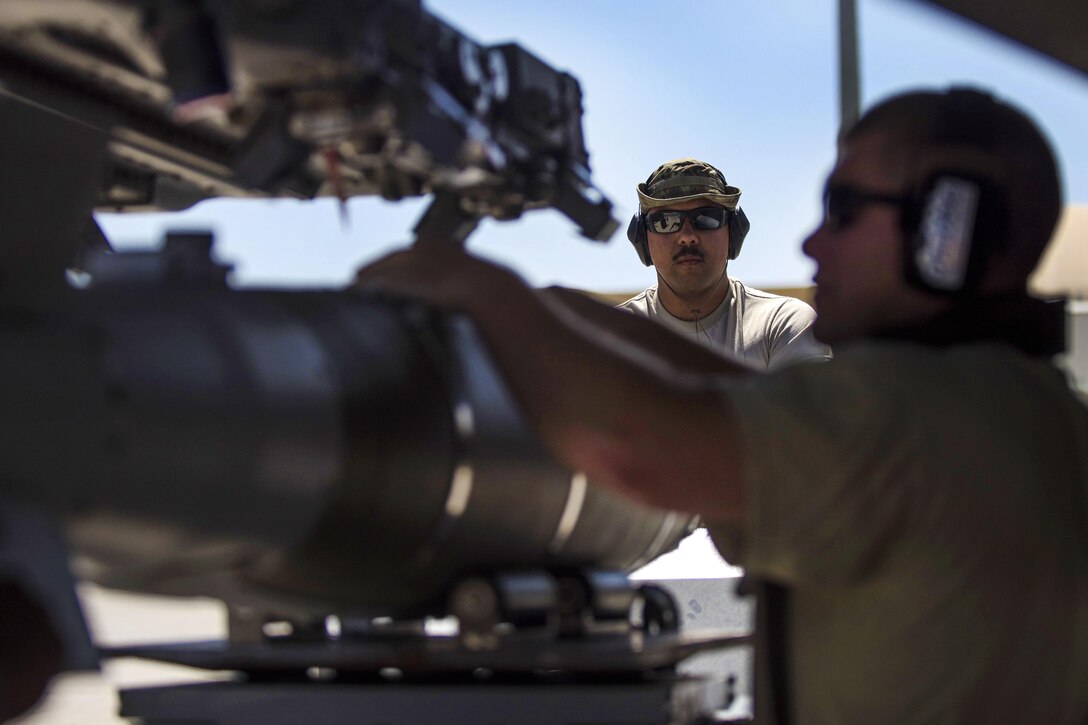 Air Force Senior Airman Jorge Martinez, left, and Tech. Sgt. Joseph McCullough load a guided bomb onto an F-16C Fighting Falcon aircraft at Bagram Airfield, Afghanistan, June 7, 2016. Martinez and McCullough are weapons maintainers assigned to the 455th Expeditionary Aircraft Maintenance Squadron. Air Force photo by Senior Airman Justyn M. Freeman
