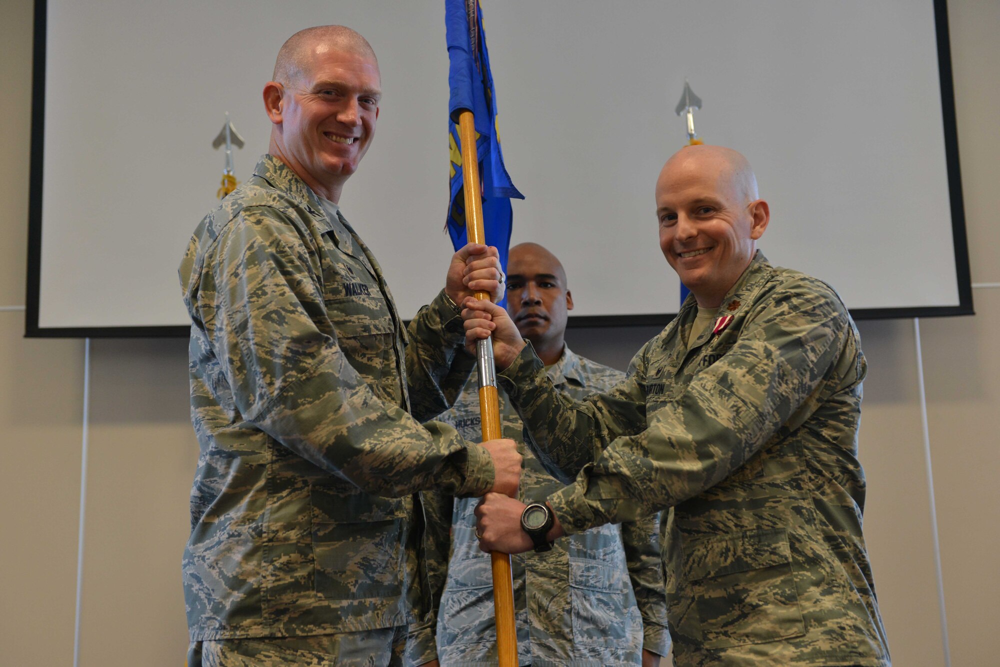 U.S. Air Force Maj. Bennet Burton, 39th Contracting Squadron outgoing commander, relinquishes command of the 39th CONS to U.S. Air Force Col. John Walker, 39th Air Base Wing commander, June 13, 2016, at Incirlik Air Base, Turkey. Burton led 43 military and civilian contracting professionals engaged in the solicitation and award of more than $20 million annually and the administration of more than $100 million in awarded contracts. (U.S. Air Force photo by Senior Airman John Nieves Camacho/Released)