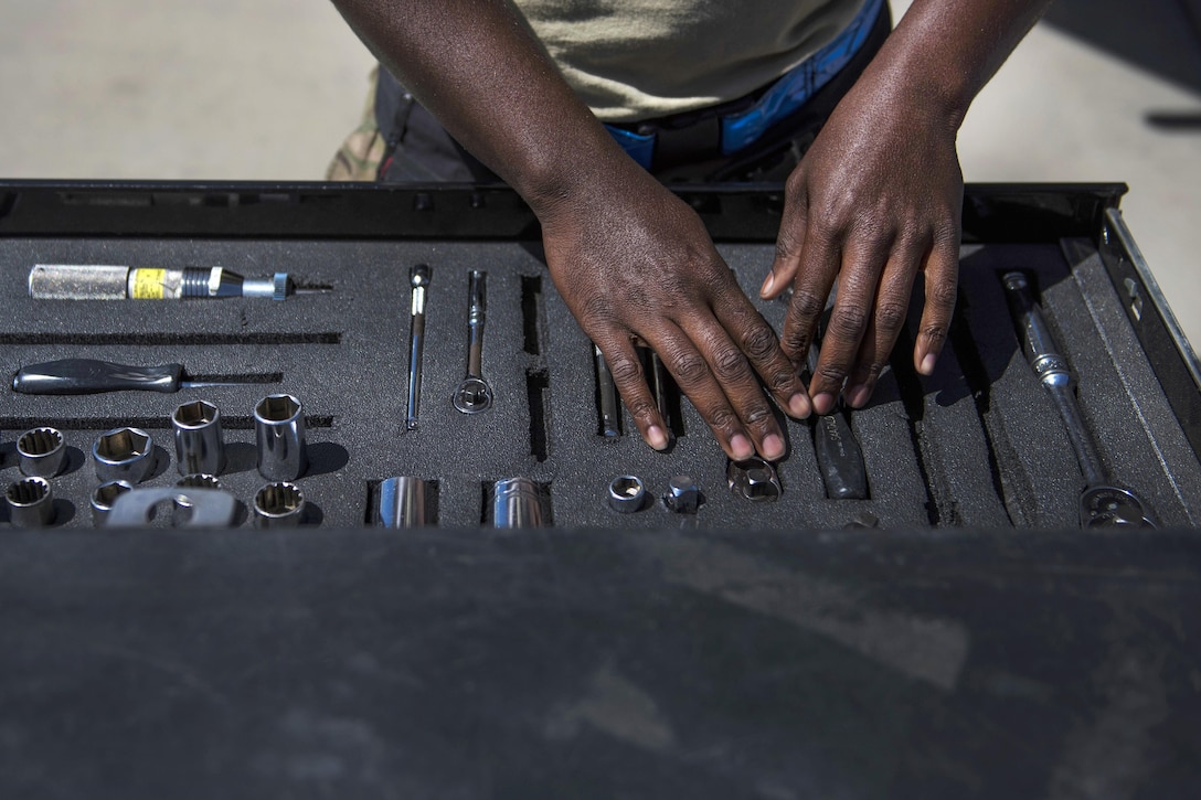 Air Force Senior Airman Clarence Williams prepares tools used to load guided bombs on an F-16C Fighting Falcon aircraft at Bagram Airfield, Afghanistan, June 7, 2016. Williams is a weapons maintainer assigned to the 455th Expeditionary Aircraft Maintenance Squadron. Air Force photo by Senior Airman Justyn M. Freeman