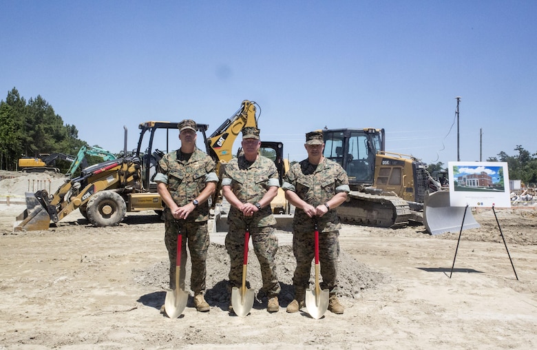 From left to right, Master Gunnery Sgt. Chad Ramsey, senior enlisted advisor of Expeditionary operations training group; Maj. Gen. W. Lee Miller, commanding general of II Marine Expeditionary Force; Col. Jeffrey Kenney, officer-in-charge of EOTG, break ground on the facility’s new training center site at Stone Bay, Camp Lejeune, N.C., June 8, 2016. The new facility, slated for completion in March 2017, will feature a simulated entry control point, embassy offices, a tactical exercise control group center and weapons storage. (U.S. Marine Corps photo by Cpl. Paul S. Martinez/Released)