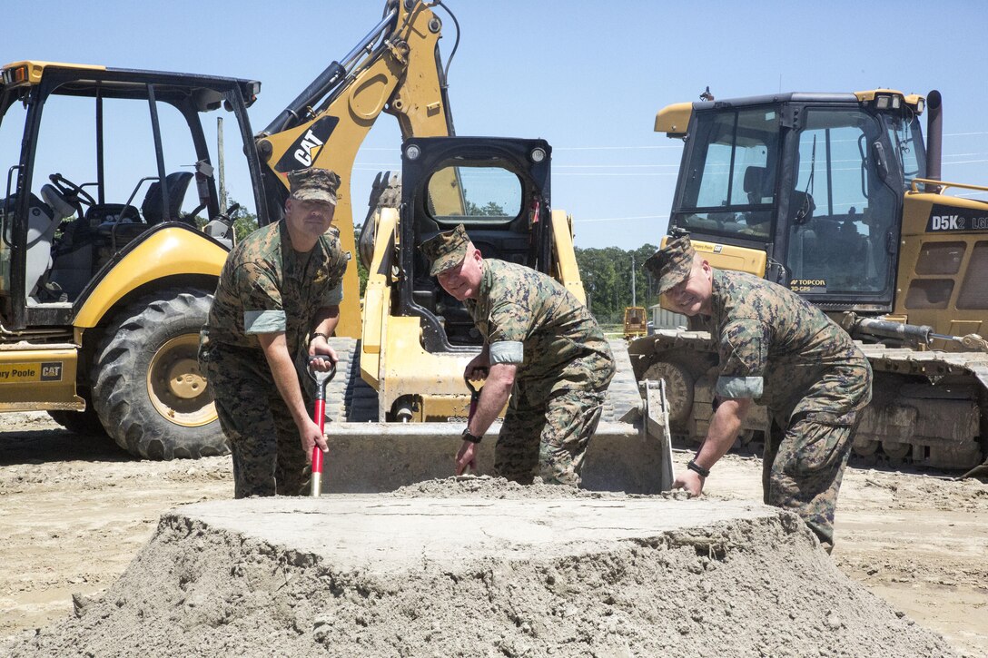 From left to right, Master Gunnery Sgt. Chad Ramsey, senior enlisted advisor of Expeditionary operations training group; Maj. Gen. W. Lee Miller, commanding general of II Marine Expeditionary Force; Col. Jeffrey Kenney, officer-in-charge of EOTG break ground on the facility’s new training center site at Stone Bay, Camp Lejeune, N.C., June 8, 2016. The new facility, slated for completion in March 2017, will feature a simulated entry control point, embassy offices, a tactical exercise control group center and weapons storage. (U.S. Marine Corps photo by Cpl. Paul S. Martinez/Released)