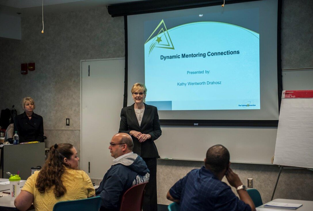 Kathy Wentworth Drahosz, president of The Training Connection, Inc., speaks during a level 1 mentor/mentee training session for associates at Defense Logistics Agency Land and Maritime. 