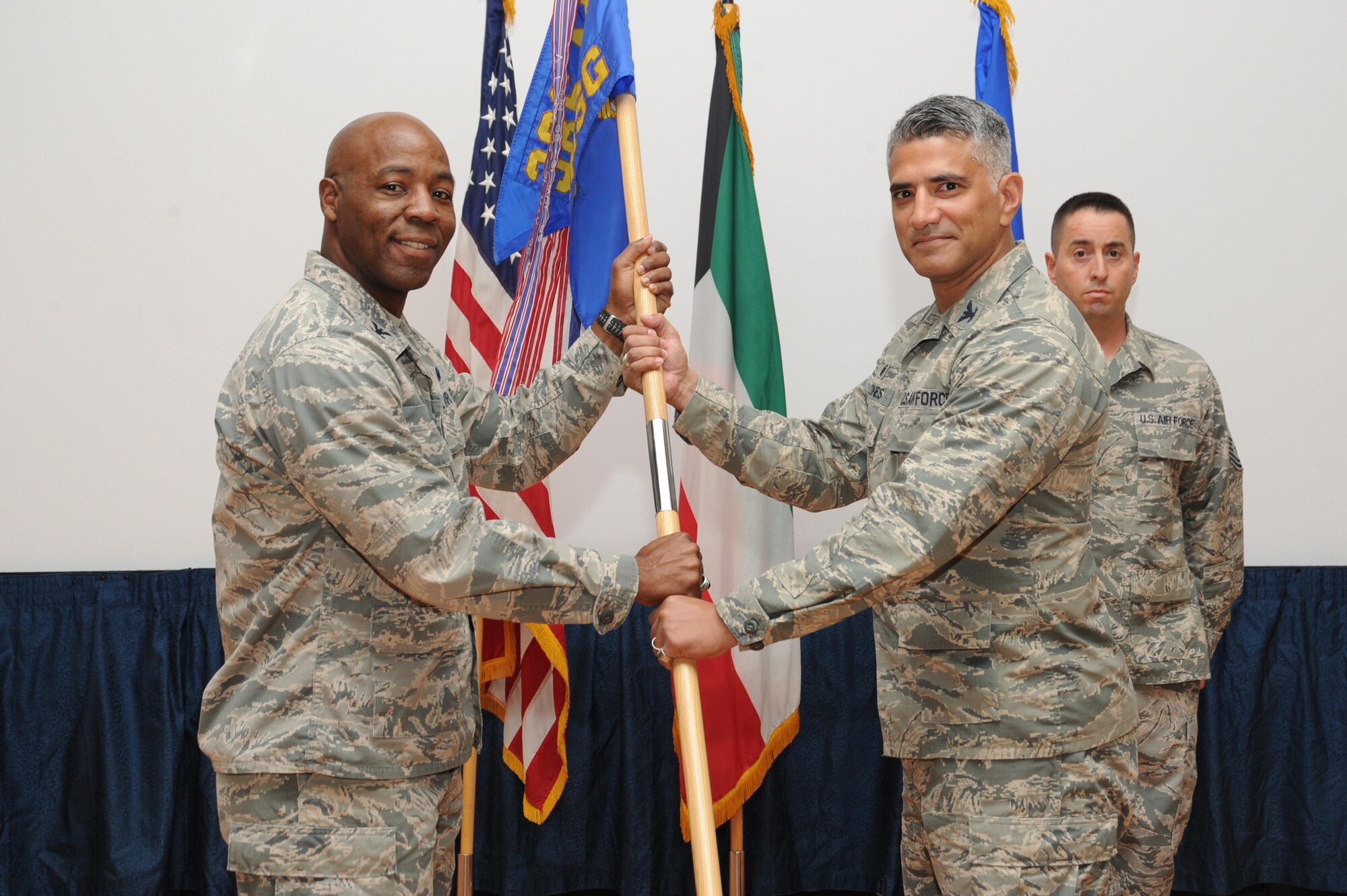 Col. Michael Jones assumes command of the 386th Expeditionary Mission Support Group and receives the guidon from Col. Clarence Lukes Jr., 386th Air Expeditionary Wing commander, during a change of command ceremony at an undisclosed location in Southwest Asia, June 12, 2016. Prior to assuming command of the 386 EMSG, Jones served as inspector general of the West Virginia National Guard at Joint Forces Headquarters in Charleston, West Virginia. Jones will oversee six combat squadrons providing installation and sortie generation support in diverse functions such as force support, security forces, logistics, contracting, communications and civil engineering. (U.S. Air Force photo by Senior Airman Zachary Kee)