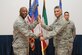 Col. Michael Jones assumes command of the 386th Expeditionary Mission Support Group and receives the guidon from Col. Clarence Lukes Jr., 386th Air Expeditionary Wing commander, during a change of command ceremony at an undisclosed location in Southwest Asia, June 12, 2016. Prior to assuming command of the 386 EMSG, Jones served as inspector general of the West Virginia National Guard at Joint Forces Headquarters in Charleston, West Virginia. Jones will oversee six combat squadrons providing installation and sortie generation support in diverse functions such as force support, security forces, logistics, contracting, communications and civil engineering. (U.S. Air Force photo by Senior Airman Zachary Kee)