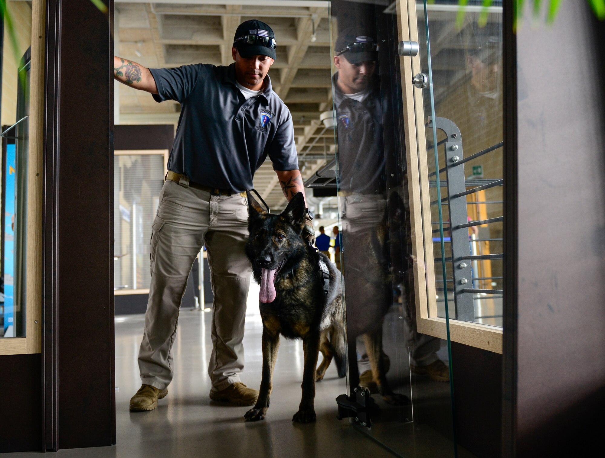 U.S. Army Sgt. Jose Rivera, 525th Military Working Dog Detachment explosive detector MWD handler, and MWD Kika prepare to enter a room while participating in a detection training in Venice, Italy, July 8, 2016. The U.S. Air Force 31st Security Forces Squadron, Venezia Polizia and 525th MWD Detachment often train together to learn from each other and increase interoperability in the event of a real world scenario. (U.S. Air Force photo by Senior Airman Krystal Ardrey/Released)