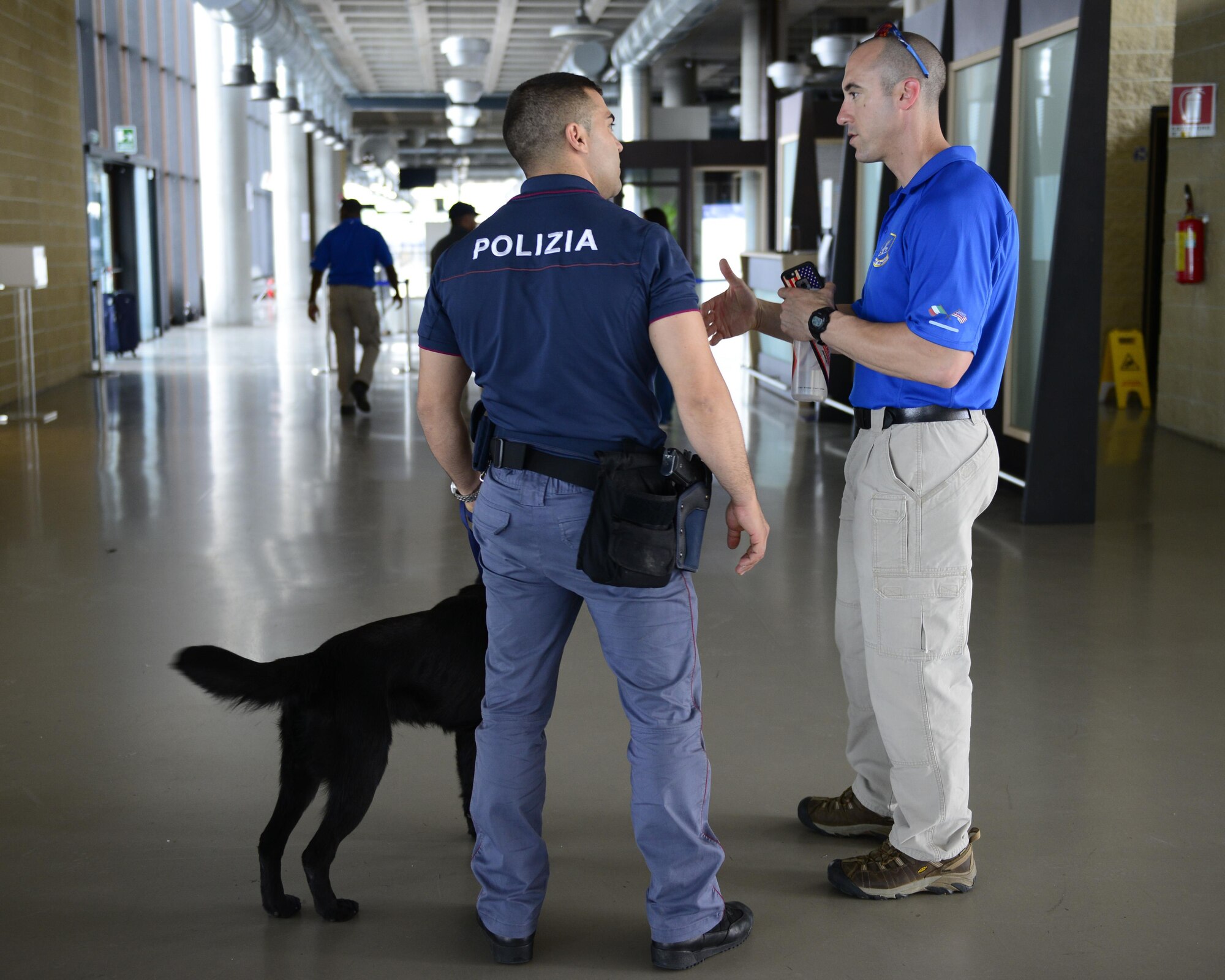 U.S. Air Force Lt. Col. Damian Schlussel, right, 31st Security Forces Squadron commander, speaks with a Venezia Polizia Locale officer during a working dog training in Venice, Italy, July 8, 2016. The 31st SFS partnered with the U.S. Army 525th MWD Detachment and Venezia Polizia Locale to provide detection training for the working dogs and their handlers. (U.S. Air Force photo by Senior Airman Krystal Ardrey/Released) 